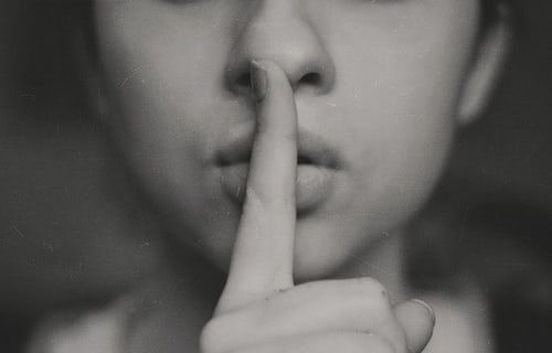 photo-1483706600674-e0c87d3fe85b | Path Social Grayscale photo of a woman doing the shushing sign to represent muting someone on Instagram.