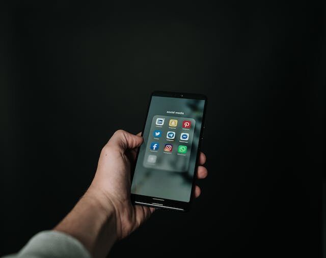 Close up of someone using their phone to access apps.