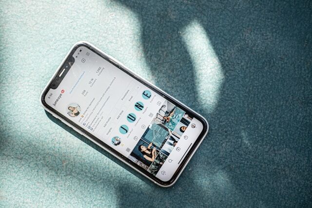 A smartphone with a woman’s aesthetically pleasing Instagram profile on the screen.