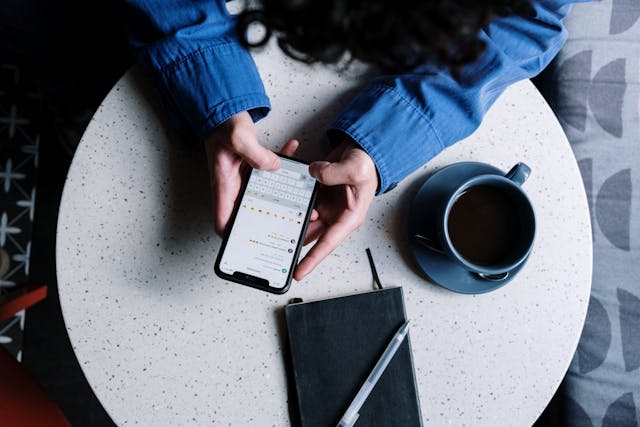 Someone typing a comment under an Instagram post on their phone.