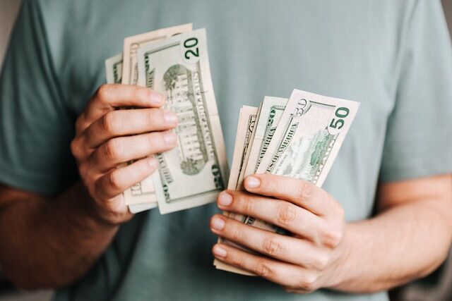 A man holding dollar bills.